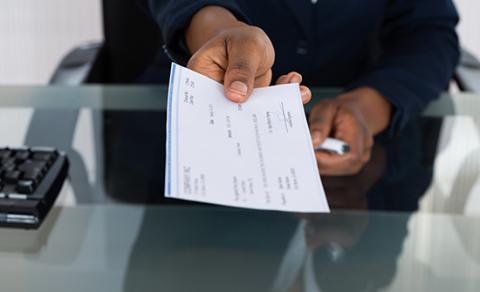 Person handing a check